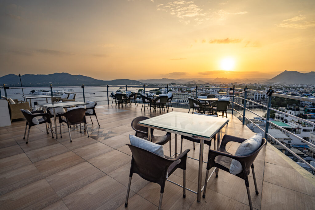 Rooftop restaurant Nazara overlooking lake at sunset with hills