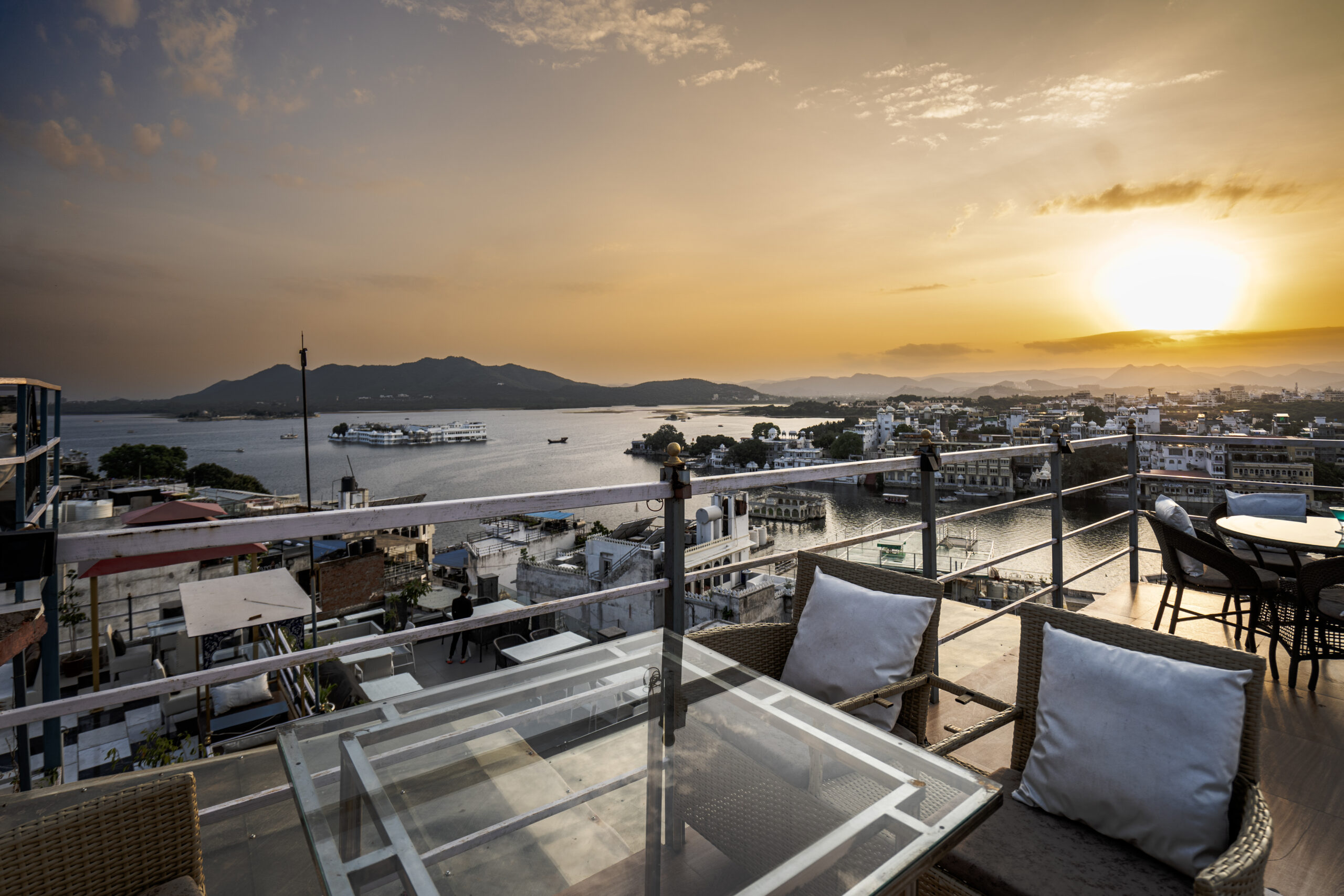 Nazara rooftop seating with lake city sunset and distant hills