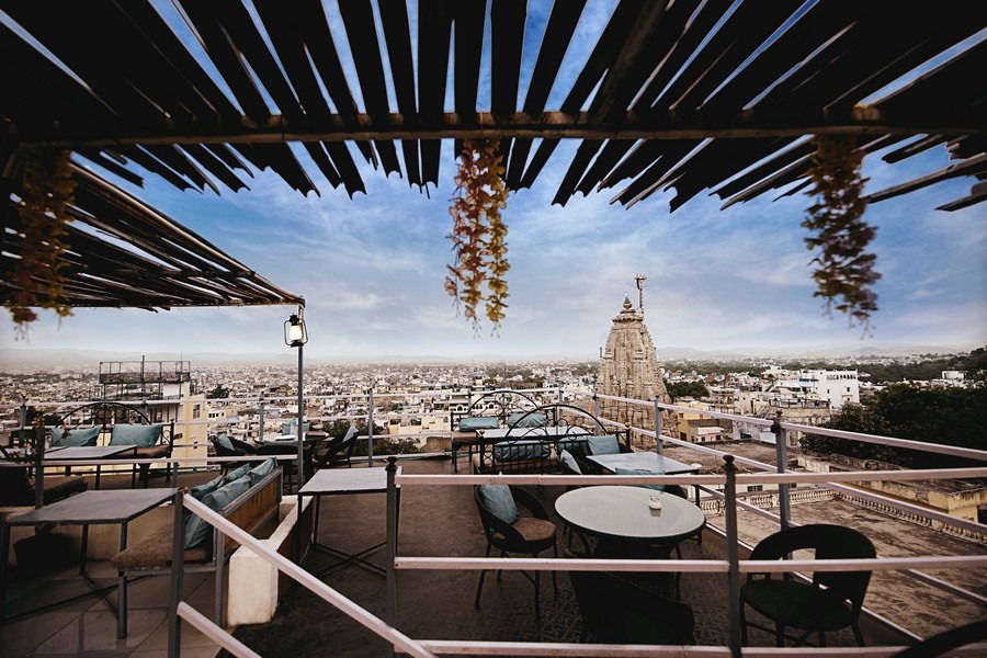 Rooftop cafe overlooking Udaipur city and temple skyline