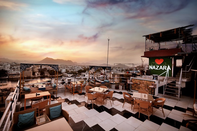 Rooftop restaurant at hotel in Udaipur near Lake Pichola with stunning lake view.